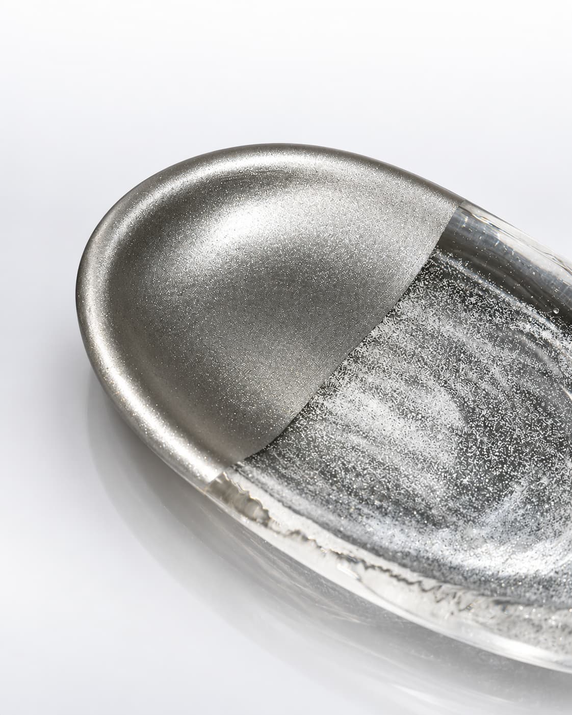 Close-up of the Silver Rift glass incense holder showing crystal texture, half-silver finish, and metal incense support.