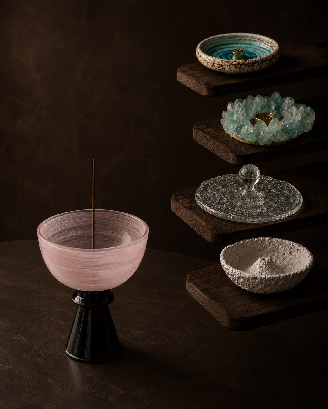 Curated incense holders collection featuring a pink glass incense holder in the foreground and four sculptural incense holders displayed on wooden stands against a warm dark background.