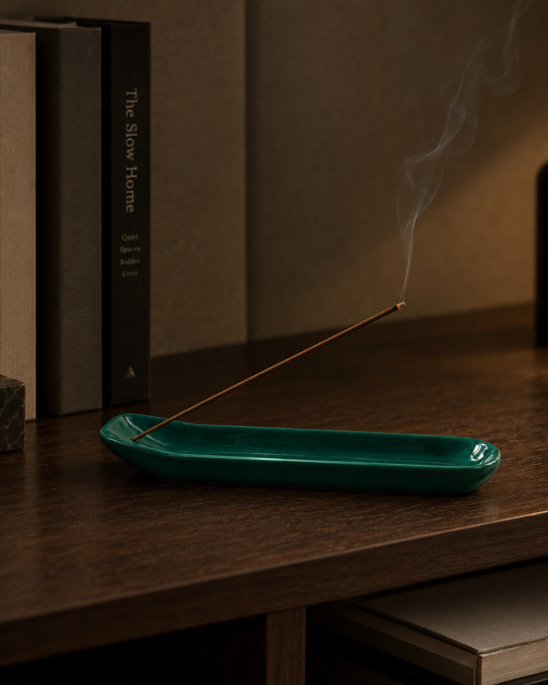 Emerald Glazed Ceramic Incense Holder on a warm wood table, holding a burning incense stick at a low angle in a calm interior setting.