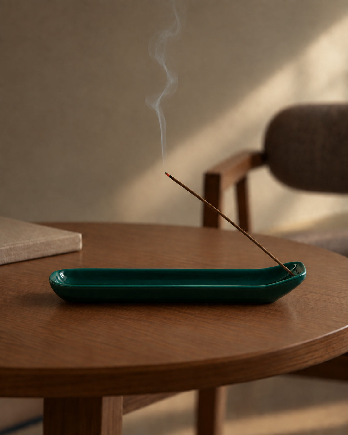 Emerald Glazed Ceramic Incense Holder with deep green glaze and elongated ash-catching tray, styled in a warm minimalist room with burning incense.