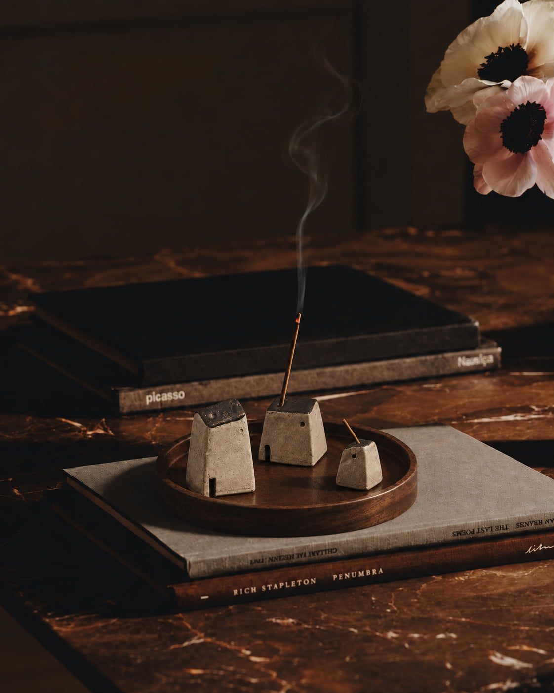 Homeward Ceramic Incense Holder Set arranged on a dark wood tray in a warm interior, featuring three sculptural ceramic forms in varied heights.