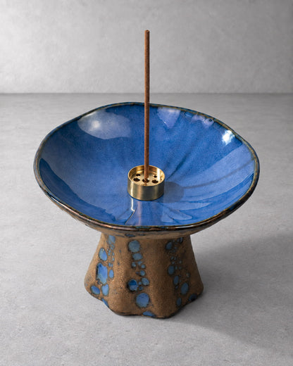 Close-up of the Azure ceramic incense holder showing blue reactive glaze, gold-tone insert, and kiln-fired pedestal details.