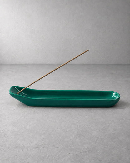Emerald green glazed ceramic incense holder with an unlit incense stick and elongated ash-catching tray.