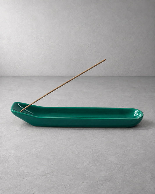 Emerald green glazed ceramic incense holder with an unlit incense stick and elongated ash-catching tray.