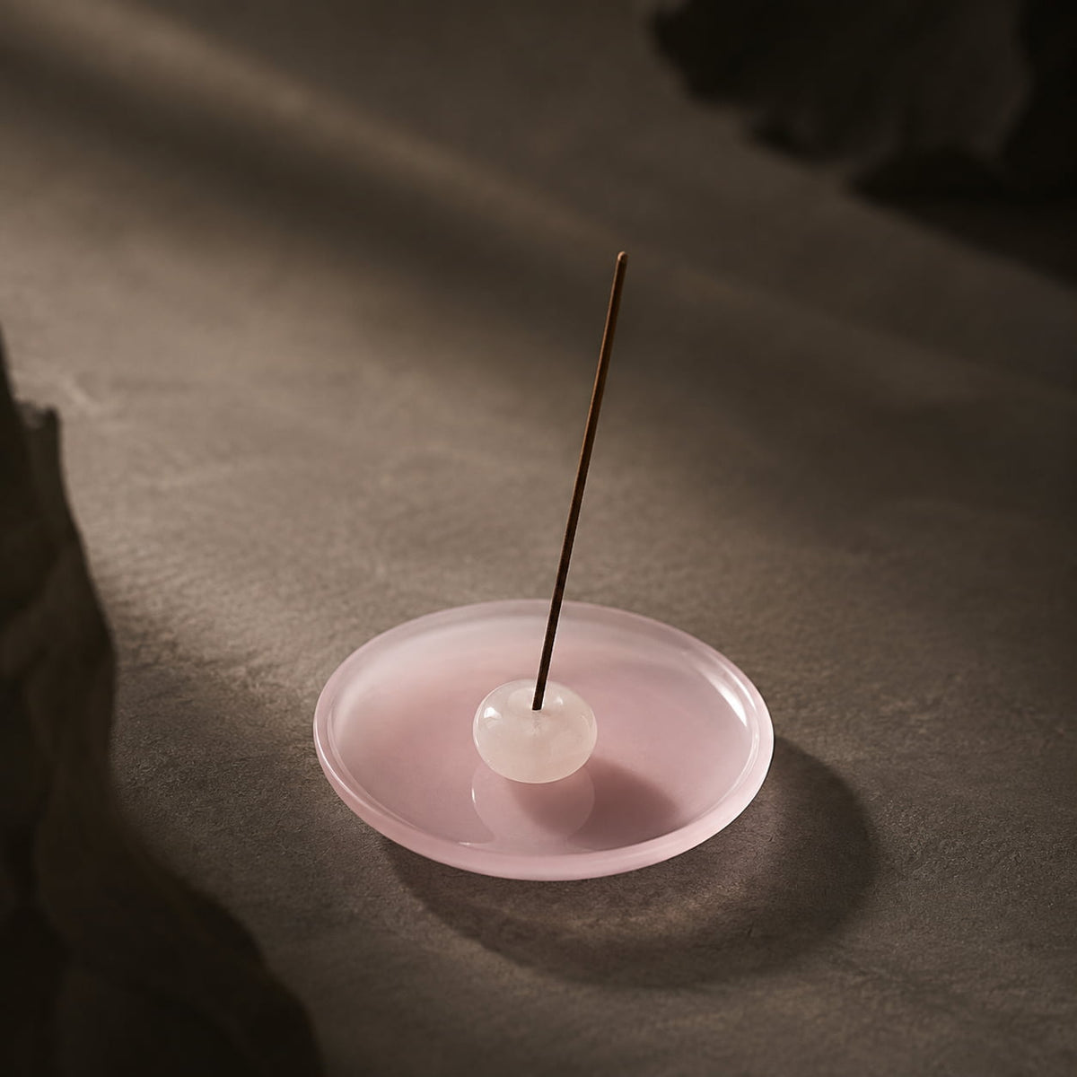 Angled view of Silent Vessel jade porcelain incense stick holder